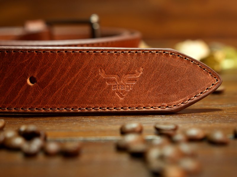 The Stagr stag pressed into the tail of a tan belt